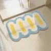 Runde Badezimmermatte mit Wellenmuster in Blau, Weiß und Gelb, ideal für moderne Badezimmer.