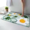 Badezimmerteppich mit Blumenmuster, weiches Material, grün-weiß-gelb, ideal für Bad und Dusche.
