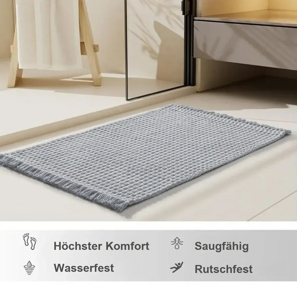 Badteppich Boho in Grau mit Fransen, rutschfest, wasserfest und saugfähig fürs Badezimmer.