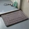 Saugfähiger Badteppich grau mit Bordüre, ideal für Badezimmer und Dusche.