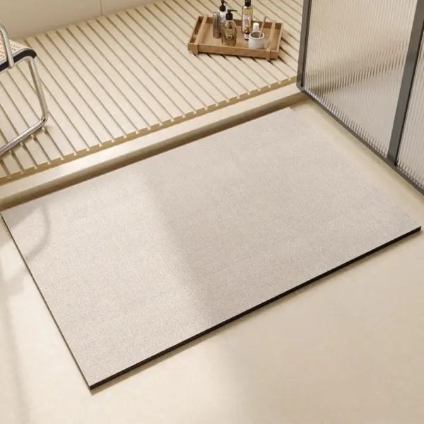 Grauer Badteppich mit schwarzem Rand, ideal für moderne Badezimmer.
