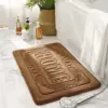 Rechteckige Badematte mit Aufschrift HOME, braun, für Badezimmer, weich und strapazierfähig.