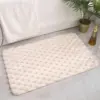 Ultra weicher Badteppich mit hexagonalem Muster, cremefarbene Badematte im Badezimmer.